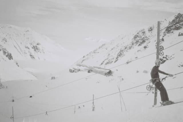 Skiing Snow Mountain Slope Skier Lift Cable Pole Winter Cold Outdoor Sport Landscape White Black-and-white Snowy Hillside Glacier Ice Alpine Adventure Recreation Travel Nature Scenery Chairlift Equipment Gear Frozen Remote Rugged Terrain Primary White