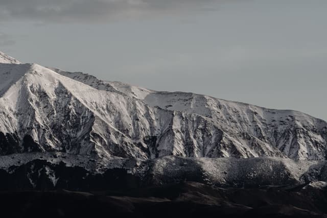Mountain Snow Peaks Landscape Nature Sky Clouds Winter Cold Rugged Scenery Outdoors Wilderness Ice Summit Ridge Horizon Majestic Remote Serene Tranquil Crisp Pristine Untouched Vast Expansive White Gray Rocky Alpine