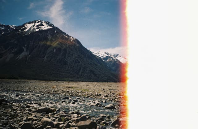 mountain snow sky clouds rocks landscape nature outdoors blue white brown sunlight horizon peaks valley terrain rugged scenic wilderness natural beauty panoramic serene peaceful majestic remote tranquil alpine rocky formation geological environment exploration adventure travel photography scenery vista breathtaking picturesque atmospheric dramatic ruggedness untouched unspoiled pristine raw elemental vast expansive grandeur awe-inspiring