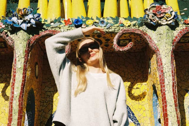 woman sunglasses sweater mosaic art flowers yellow blue green red pink architecture sunlight shadow pattern design texture outdoor casual fashion style decorative colorful bright vibrant