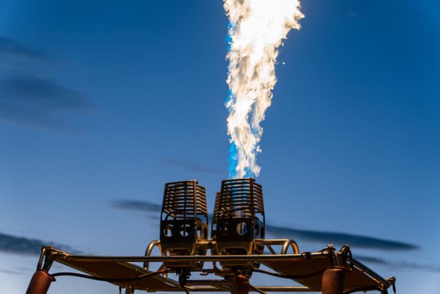 flame fire burner hot air balloon sky blue metal equipment heat combustion gas outdoors clouds structure basket ignition propulsion flight travel adventure transportation safety power energy technology vertical upward motion