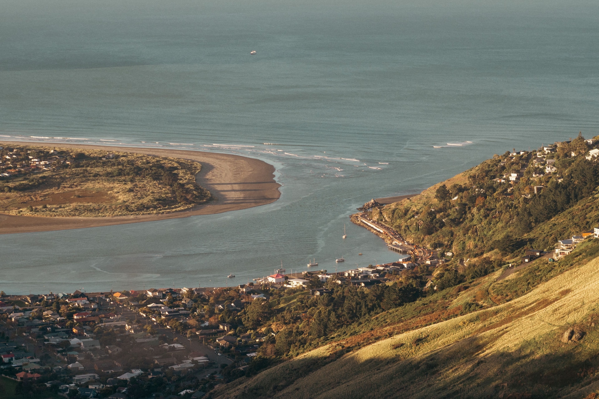 Ocean Sea Coastline Beach Hills Landscape Water Waves Shoreline Sand Green Blue Sky Nature Scenery Aerial View Peninsula Bay Inlet Horizon Cliff Vegetation Terrain Outdoors Natural Beauty Tranquil Calm Peaceful Rugged