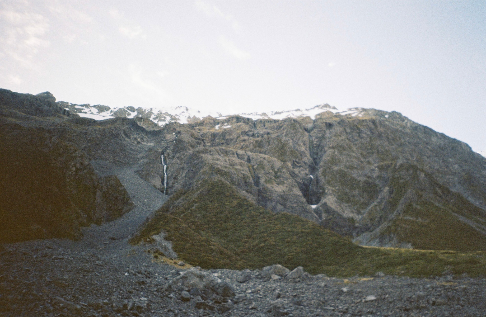 Mountain Landscape Rocks Sky Snow Green Valley Cliff Slope Ridge Hill Peak Summit Terrain Nature Outdoors Scenery Horizon Blue Rugged Wilderness Natural Formation Erosion Geological Earth Stone Craggy Majestic Remote