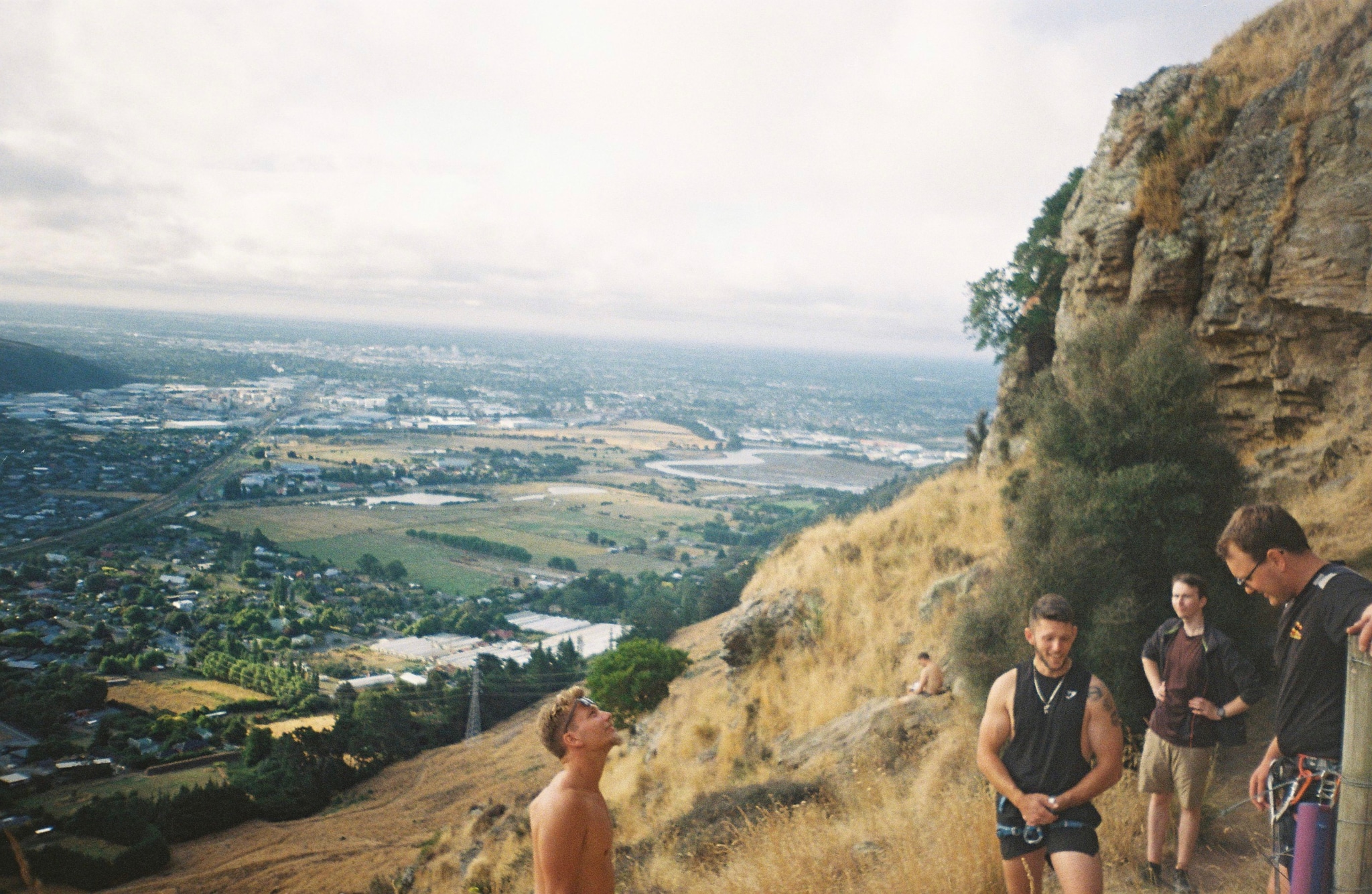 landscape mountain cliff people hiking outdoors nature sky grass valley city view rock trees primary blue clouds path trail summit exploration adventure exercise fitness group scenery panoramic rural countryside horizon plateau terrain