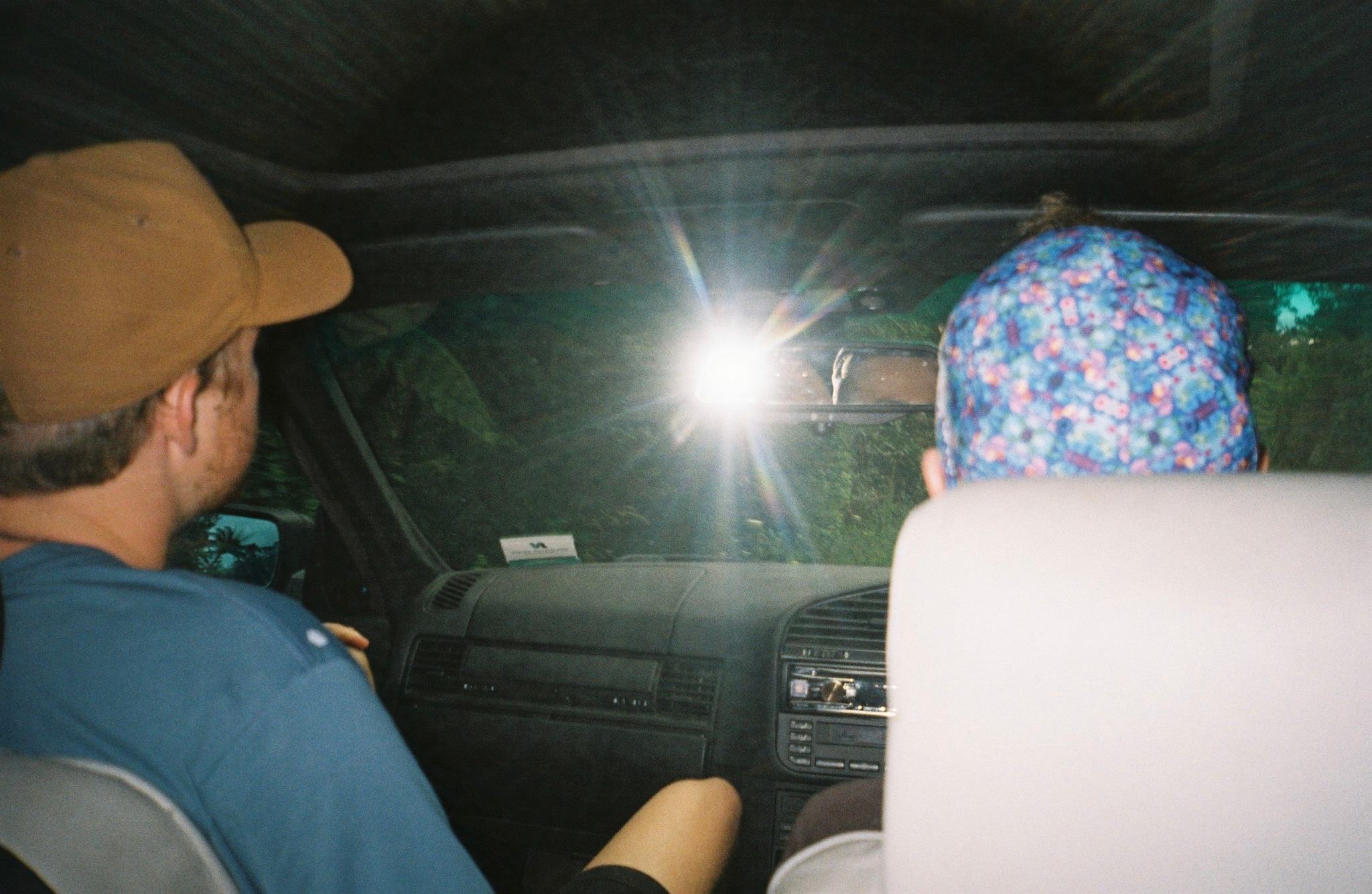 car interior dashboard steering wheel seats hats cap flash light night driving blue brown black white green