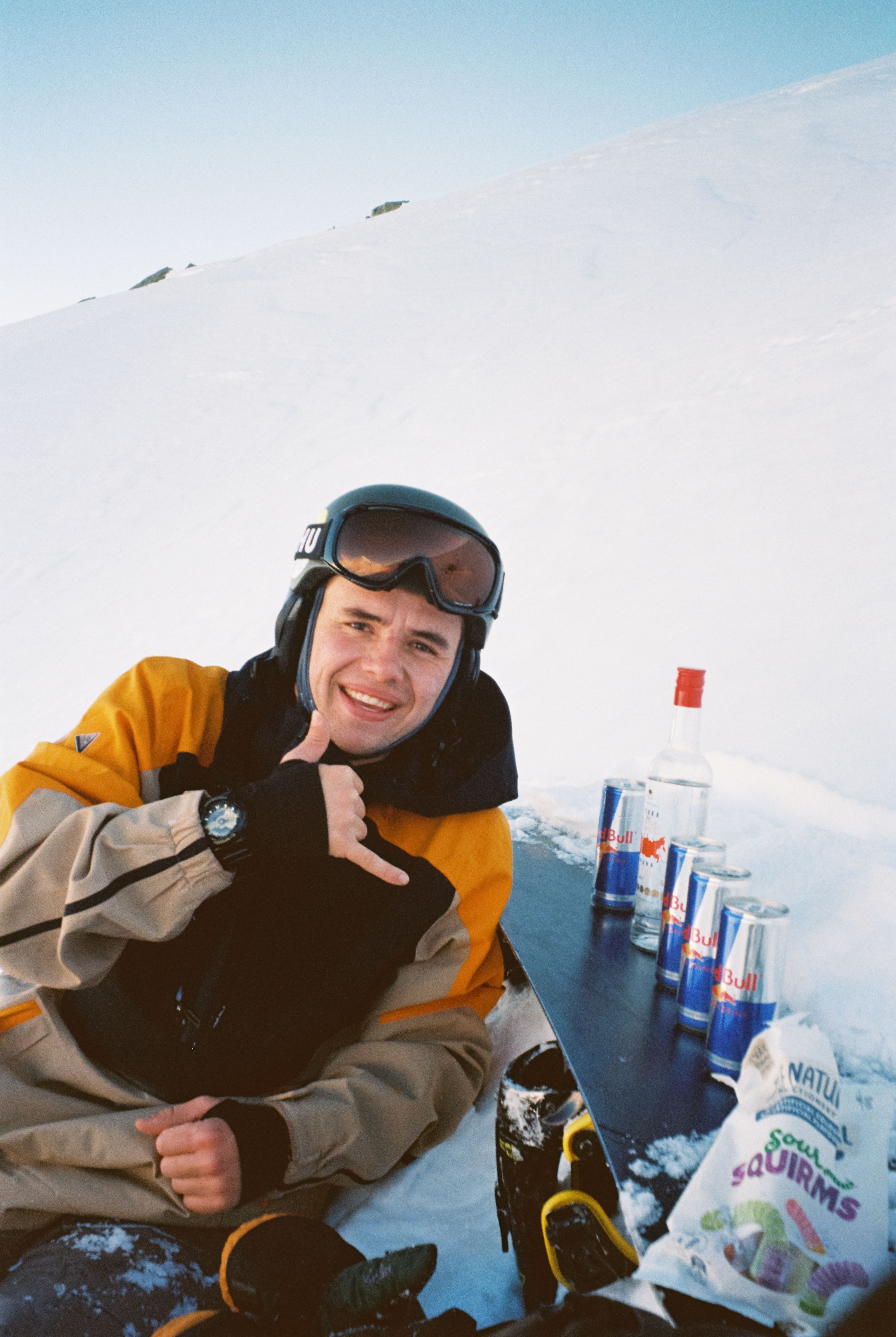 snow goggles jacket gloves snowboard bottles cans snacks blue white sky winter outdoor