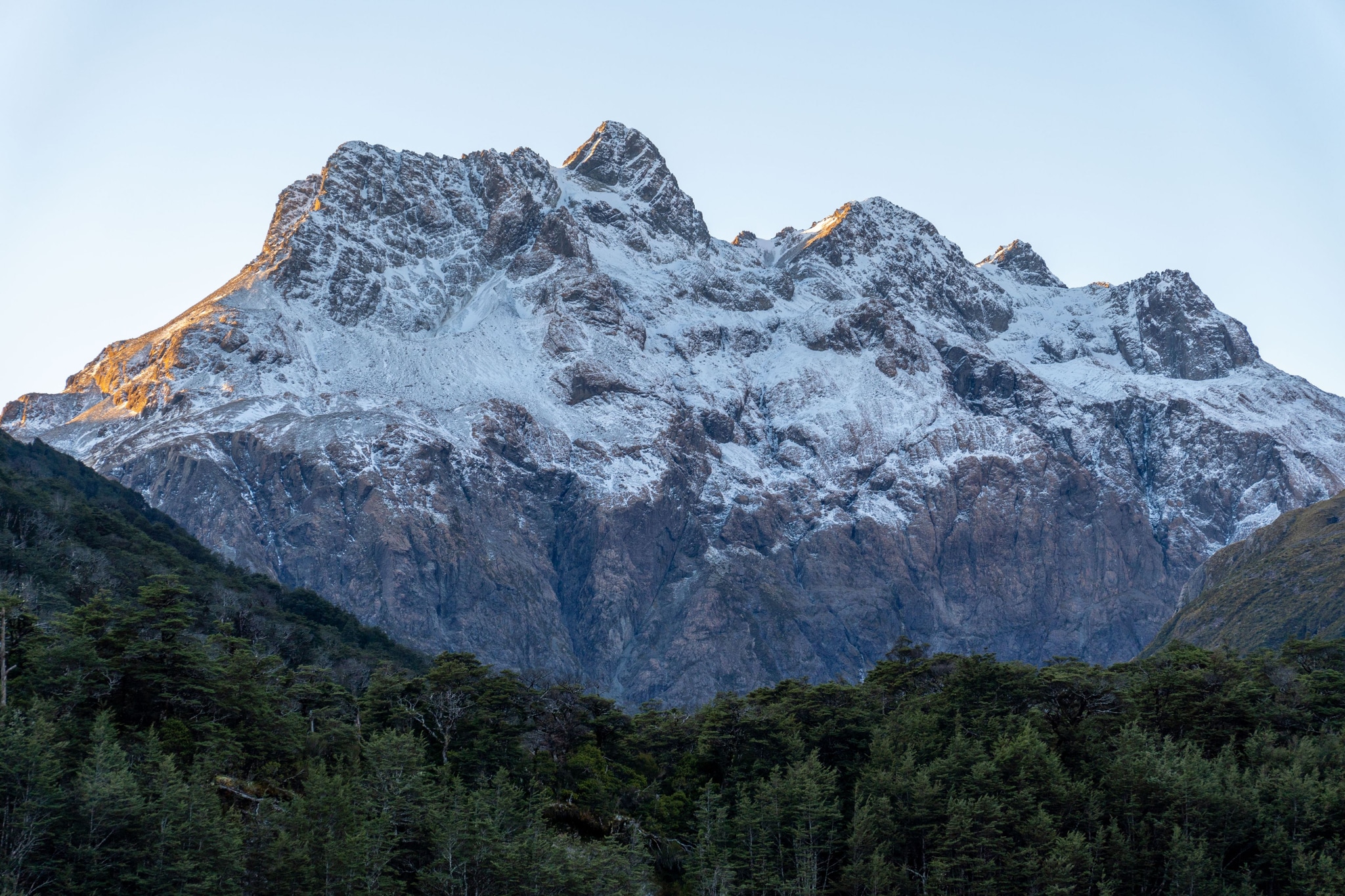 Mountain Snow Peaks Forest Trees Sky Blue White Green Nature Landscape Scenery Outdoors Rugged Majestic Natural Wilderness Summit Rocky Cliff Alpine Scenic Tranquil Serene Crisp Cold Remote Adventure Exploration